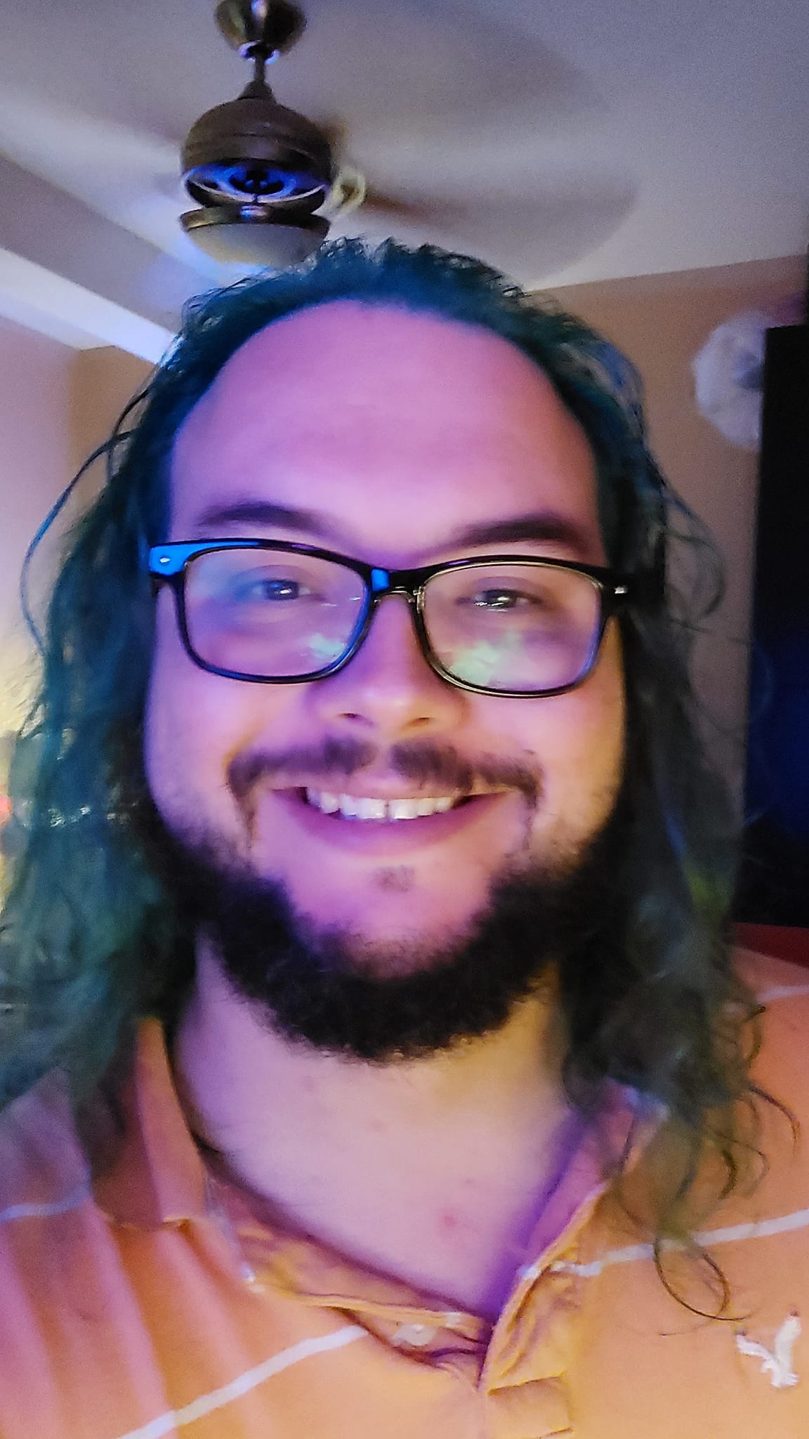 A man with long green hair sits in a computer chair, photo 4